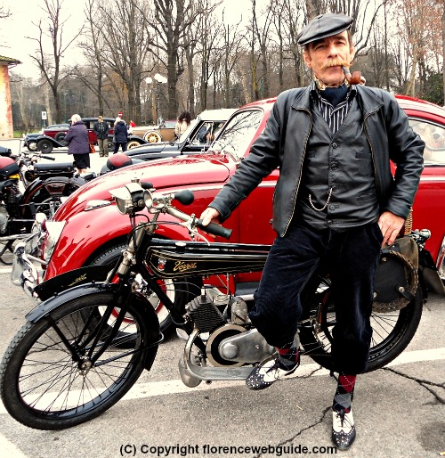 Gentleman in period garb with his vintage motorcycle at the Cascine park in Florence on Jan. 6, Feast of the Epiphany