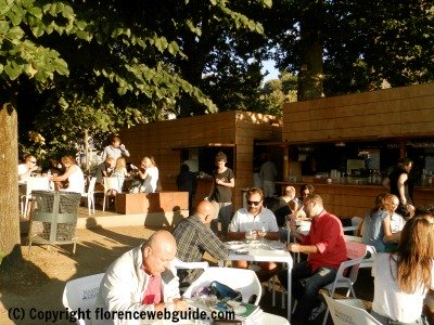 People gather in the shady piazza for an aperitivo at Easy Living