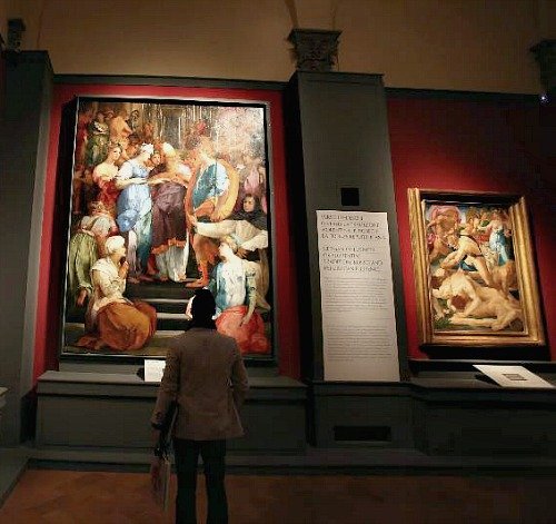 A visitor at the Pontormo and Rosso Fiorentino exhibit at Palazzo Strozzi