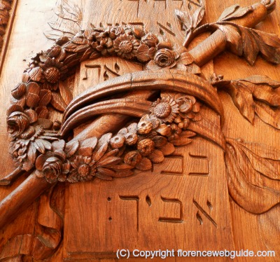 Wood door on right side of basilica with Hebrew writing