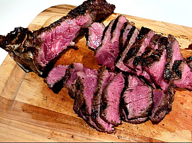 Steak sliced on cutting board