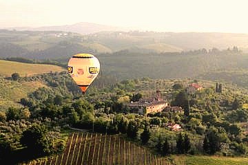 Hot air balloon coasting over the Tuscan countryside