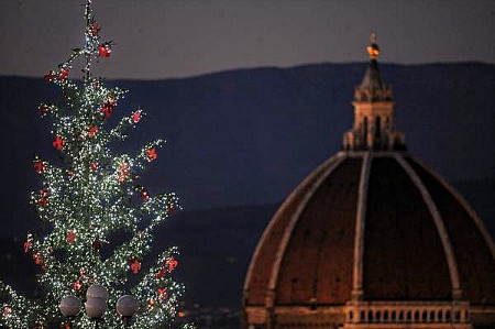 Top of Christmas tree at piazzale Michelangelo with Brunelleschi's cupola
